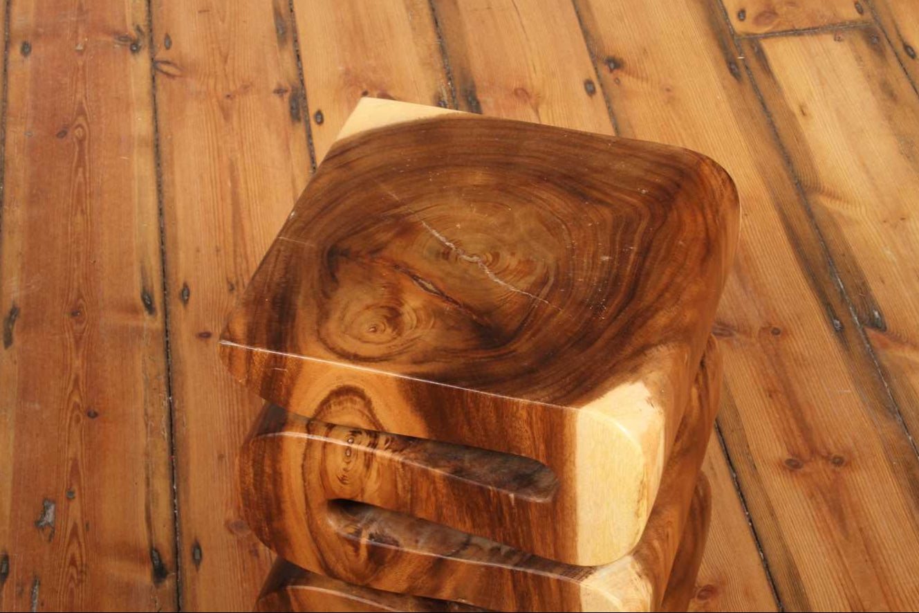 Top view of the Arus Stool highlighting its polished wood grain and natural lines