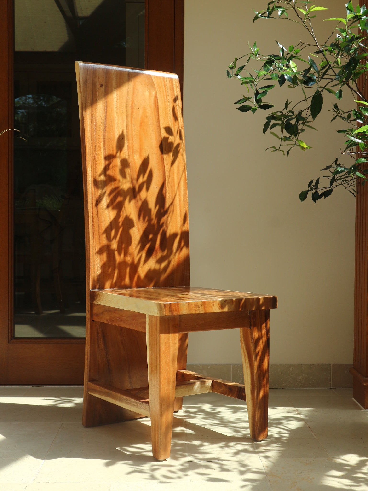 Monolit Chair in natural light with shadow play on high back panel