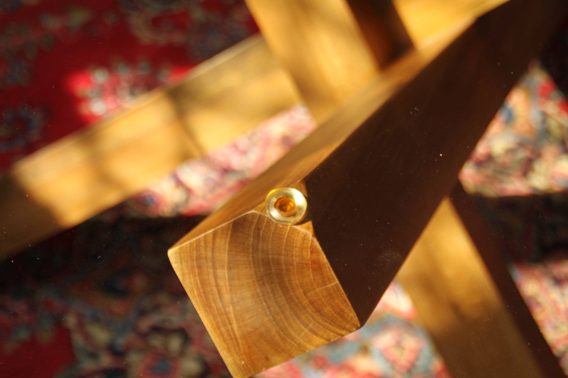 Close-up of joining of wood and glass under light