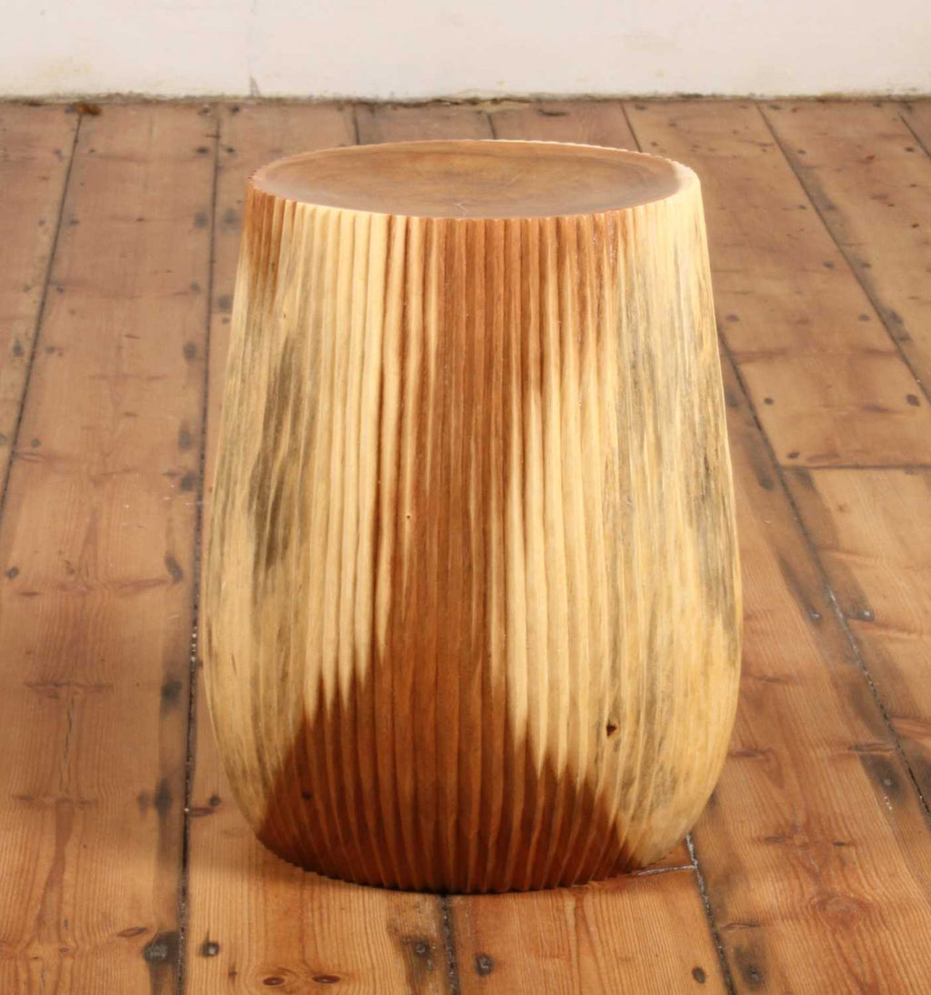 Alur Stool photographed on wooden floor in natural light