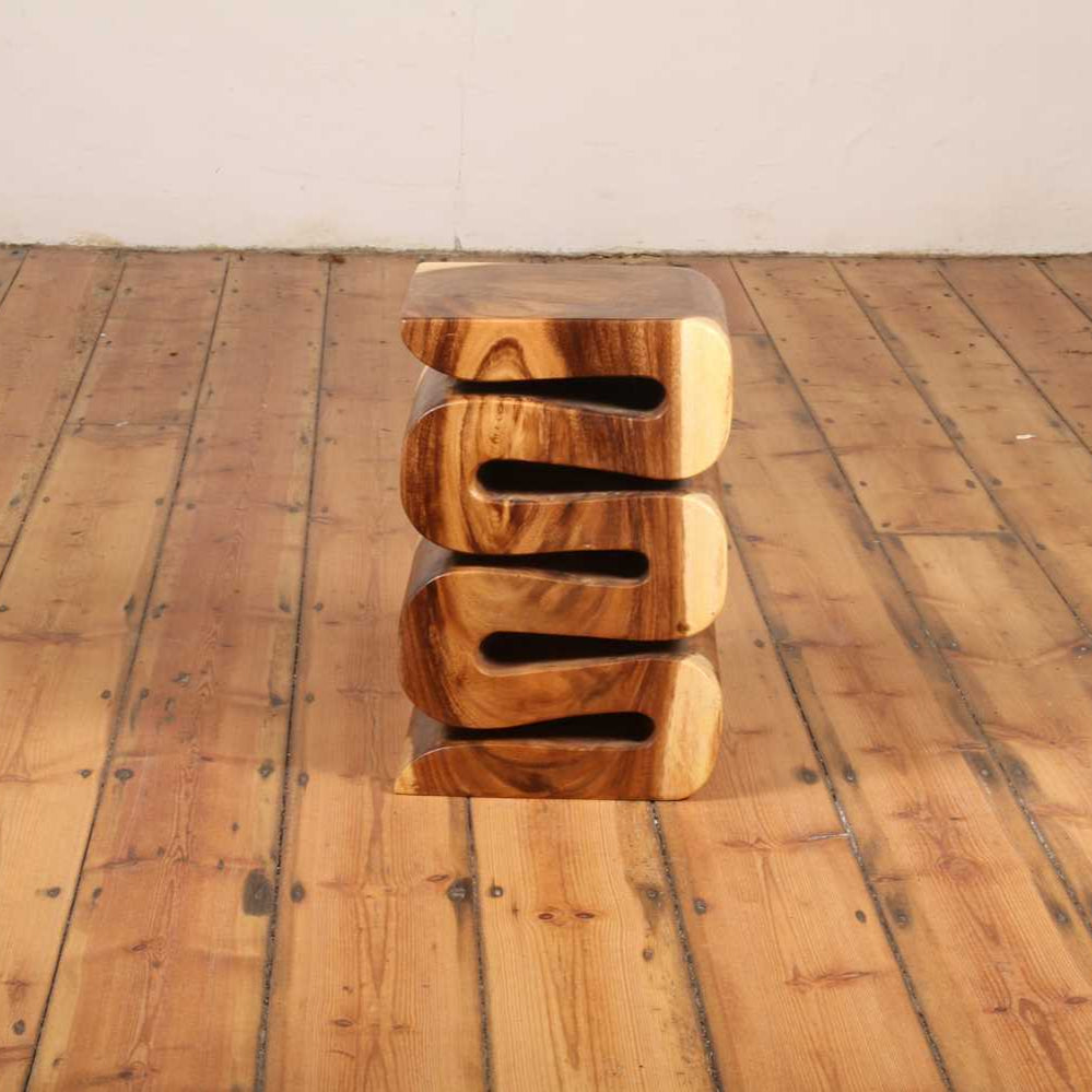 Straight-on view of the Arus Stool showing symmetrical curves and sculptural detail.