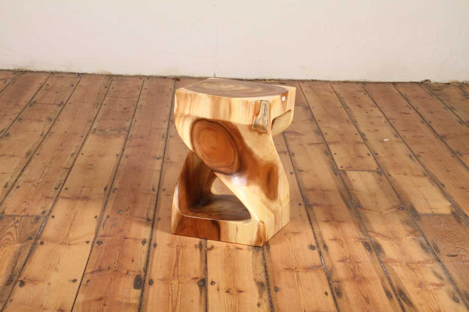 Gelung Stool viewed on wooden floor, showing full sculptural shape.