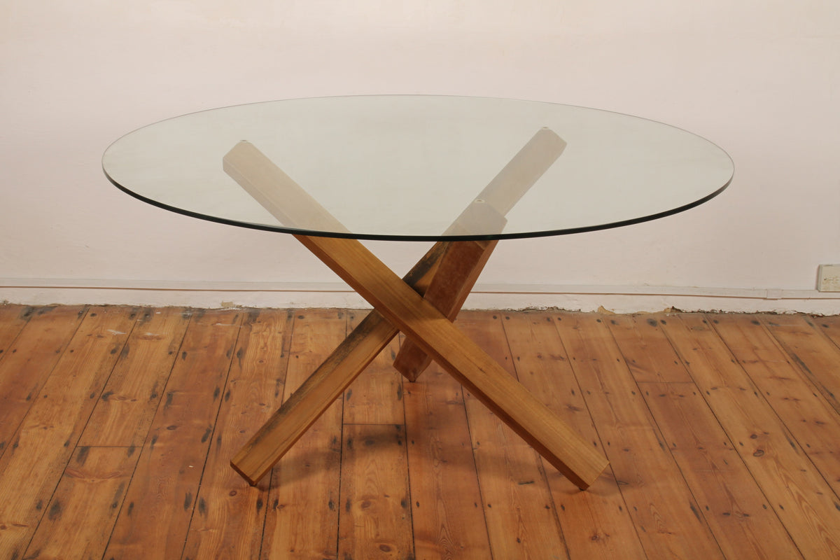 Simpang Round Table full view with intersecting solid teak base and round glass top